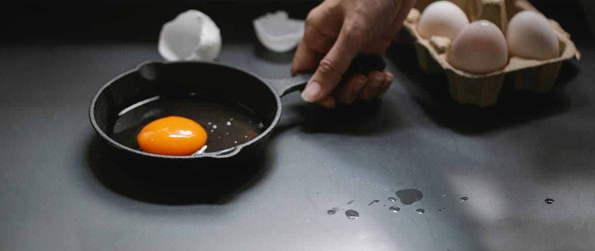 Black cast iron skillet, top down, matte seasoned surface