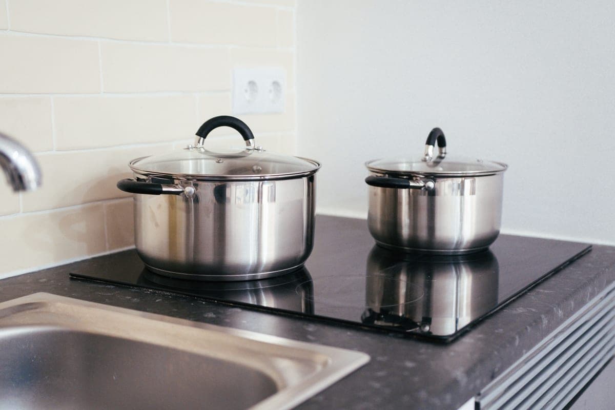 Stainless steel saucepan with a riveted handle, straight-on